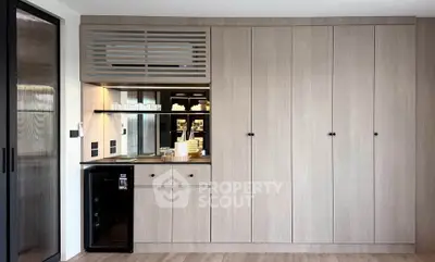 Modern kitchen with sleek cabinetry and built-in appliances in a stylish apartment.