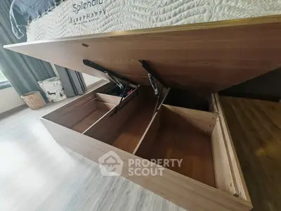 Innovative bedroom storage solution with lift-up bed frame and spacious compartments.