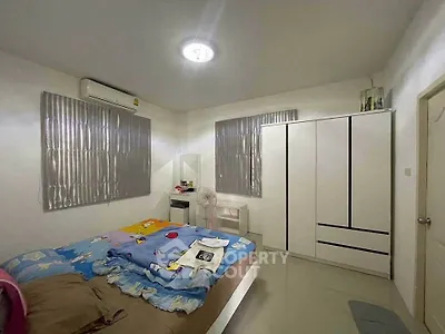 Cozy bedroom with modern wardrobe and air conditioning, perfect for restful nights.
