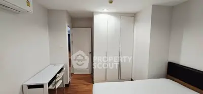 Modern bedroom with white wardrobe and sleek desk, perfect for urban living.