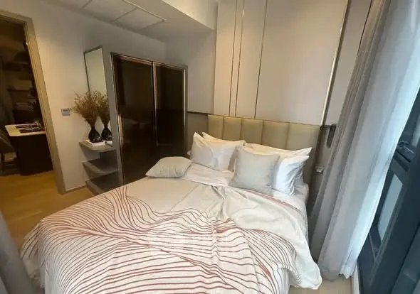 Cozy bedroom with modern decor and ample natural light