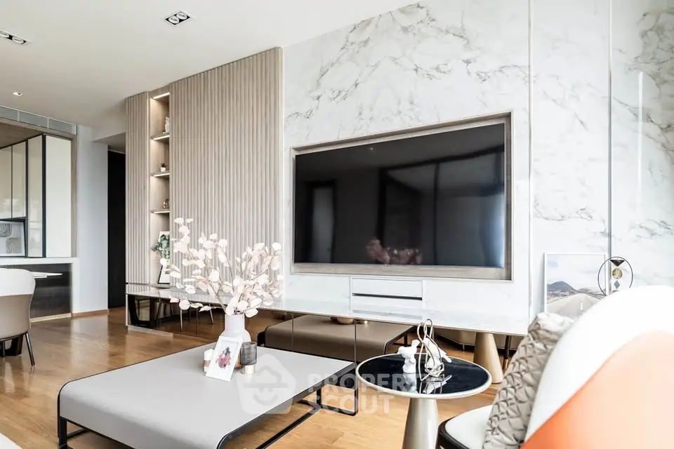 Luxurious modern living room with elegant decor and large flat-screen TV, perfect for stylish urban living.