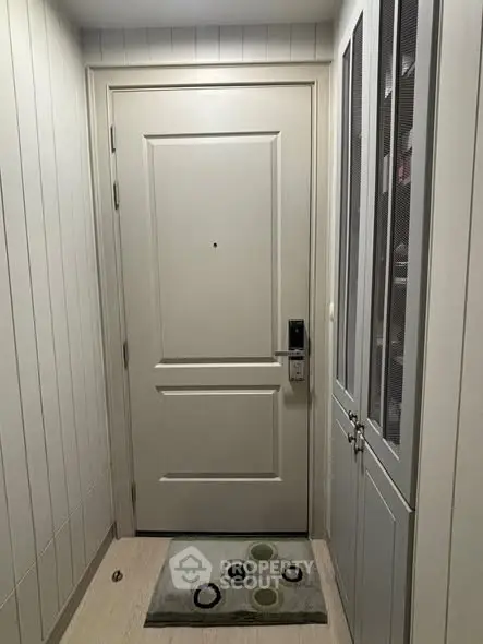 Stylish entrance with modern door and sleek storage cabinet