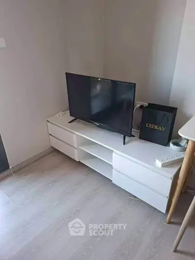 Modern living room with sleek TV stand and flat-screen TV, perfect for cozy entertainment.