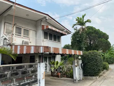 Charming two-story house with lush greenery and spacious balcony