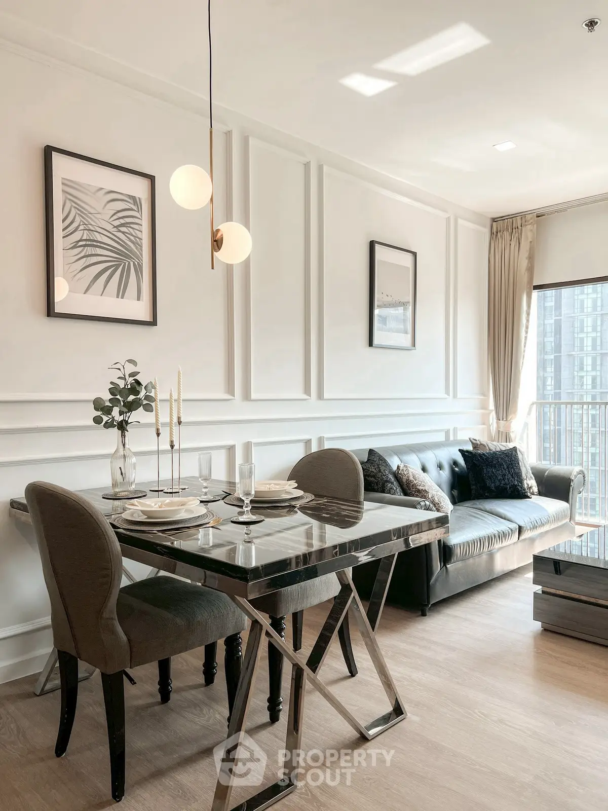 Elegant living room with modern dining area and stylish decor in a bright apartment.