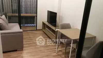 Modern living room with sleek furniture and wooden flooring in a cozy apartment.