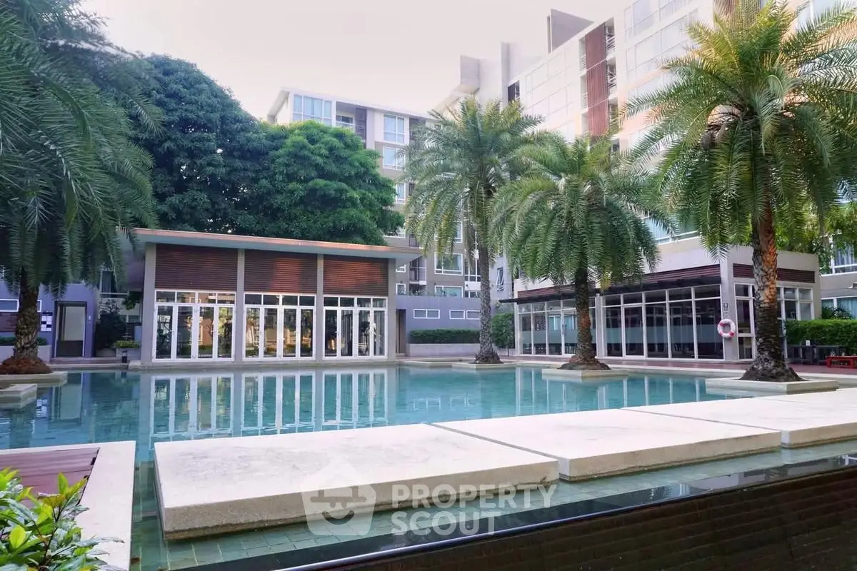 Luxurious condominium with stunning pool and lush palm trees