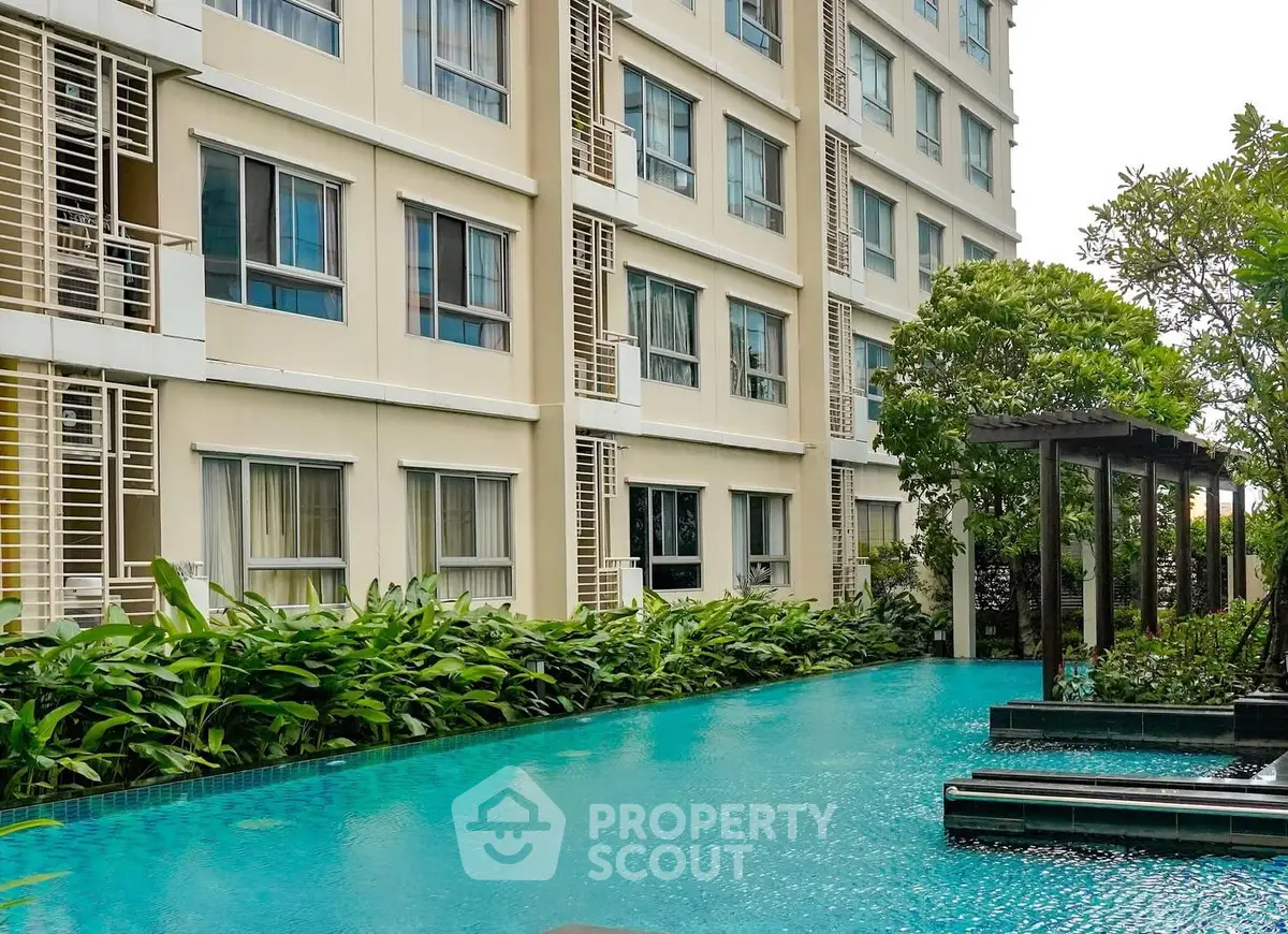 Luxurious condominium with serene poolside and lush greenery