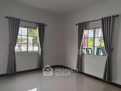 Bright empty room with large windows and elegant curtains, perfect for customization.