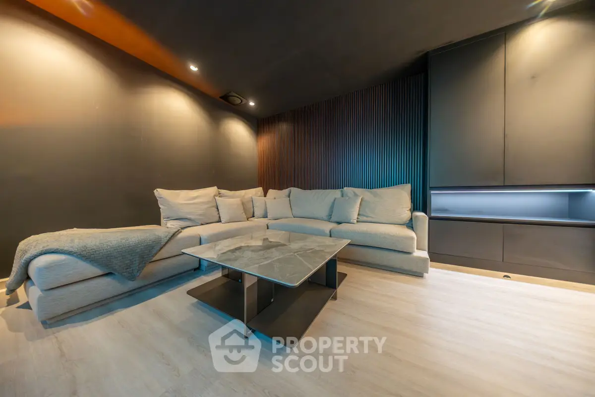 Modern living room with sleek design, featuring a large sectional sofa and stylish coffee table.