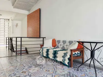 Charming interior with stylish tiled floor and cozy seating area, perfect for relaxation.