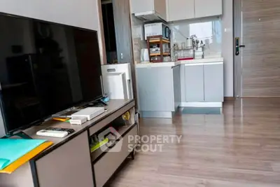 Modern apartment interior with sleek kitchen and cozy living area, featuring contemporary furniture and appliances.
