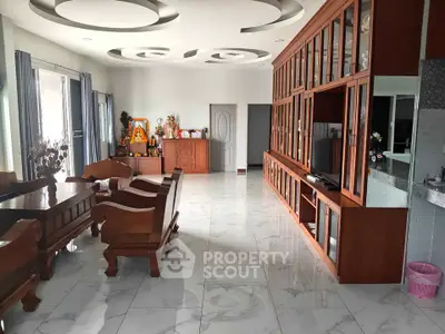 Spacious living room with elegant wooden furniture and modern ceiling design