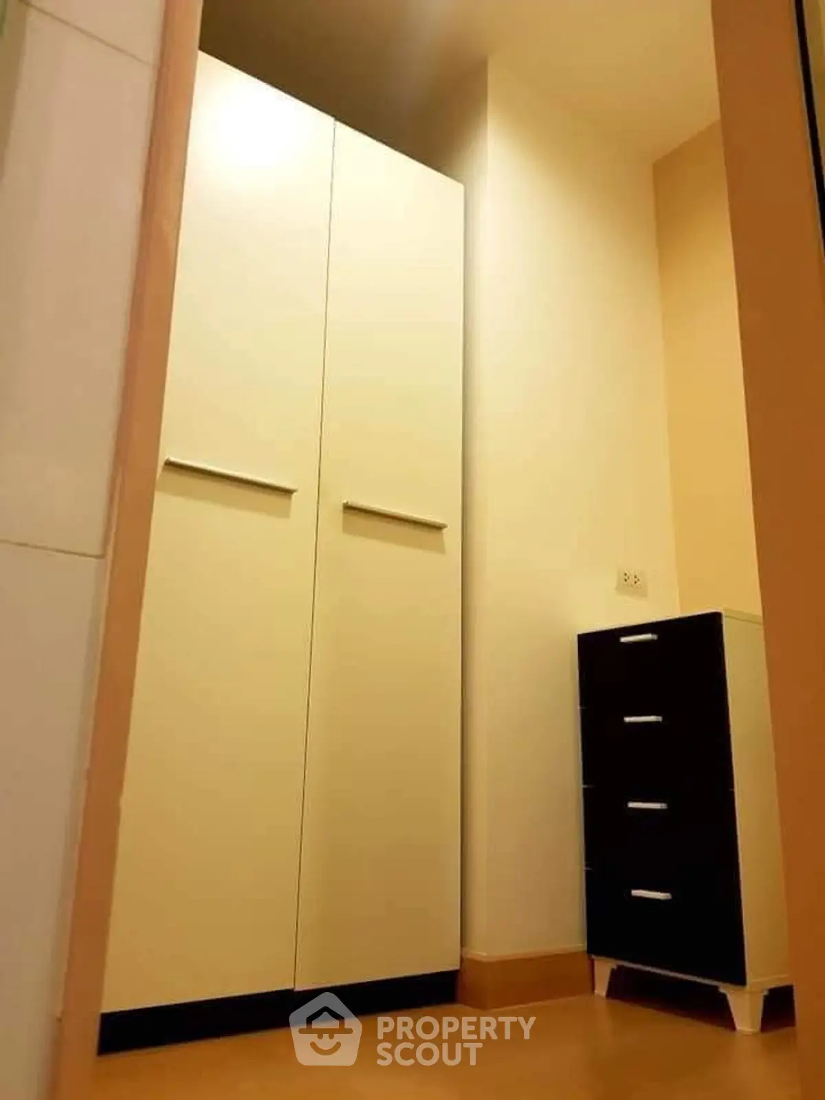 Modern storage area with sleek cabinets and drawers in a cozy corner