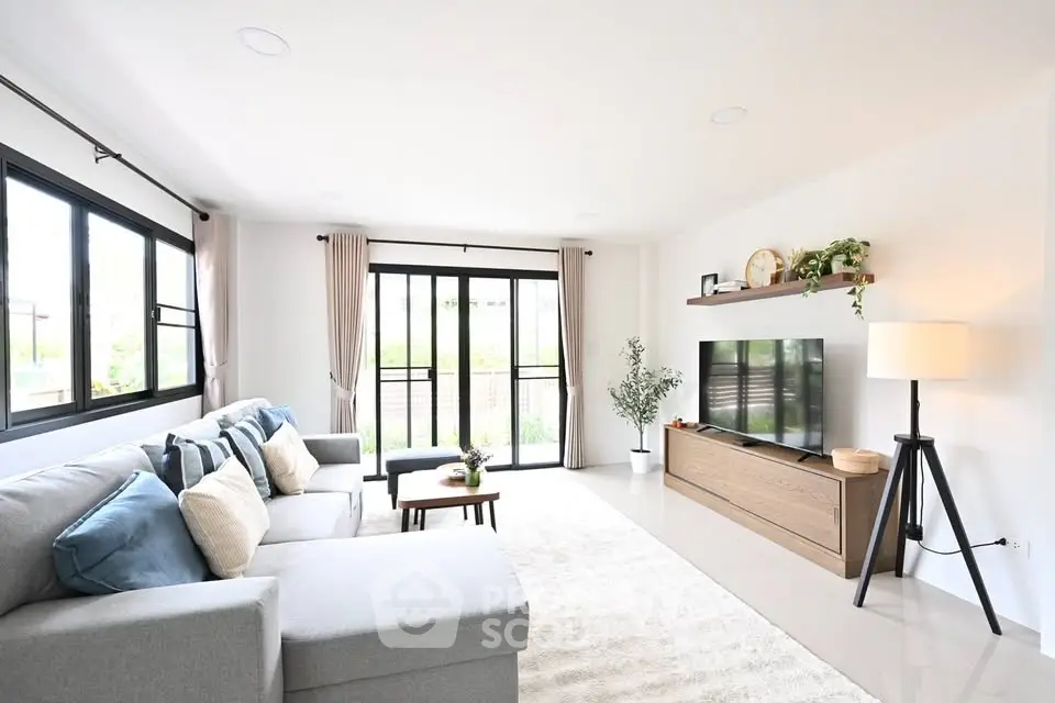 Spacious modern living room with large windows and stylish decor