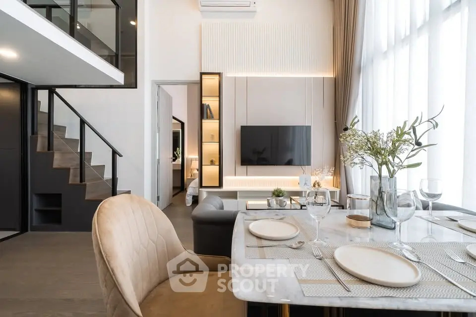 Luxurious modern living room with elegant dining area and stylish staircase