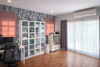 Spacious study room with modern decor and large window for natural light