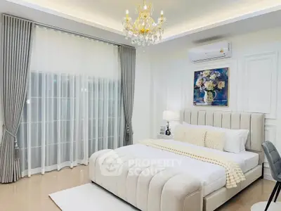 Luxurious bedroom with elegant chandelier and plush bedding