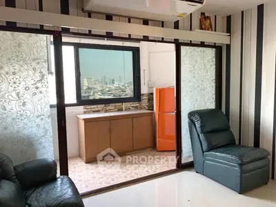 Stylish living room with city view and vibrant orange fridge