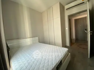 Modern bedroom with sleek design and built-in wardrobe, featuring air conditioning for comfort.
