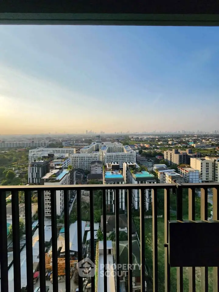 Stunning high-rise balcony view overlooking cityscape and skyline at sunset.