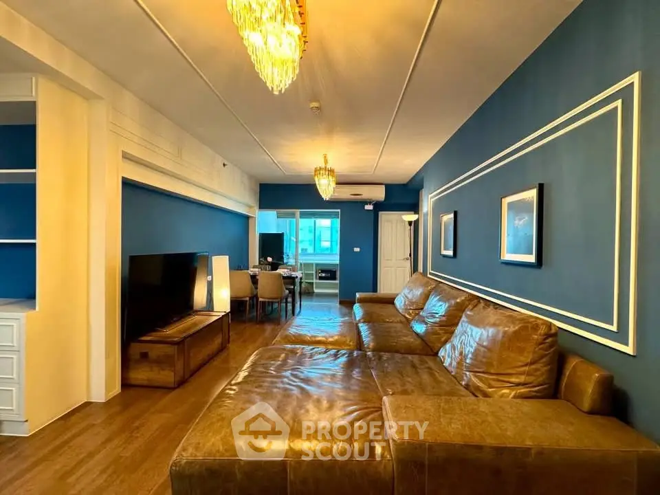 Luxurious living room with elegant blue walls and leather sofa