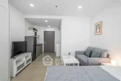 Modern studio apartment with cozy living area and compact kitchen