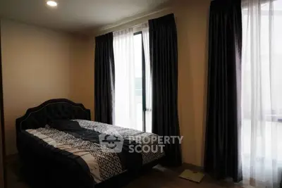 Cozy bedroom with elegant curtains and stylish bed in modern apartment