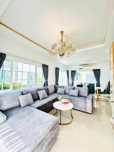 Luxurious living room with elegant chandelier and spacious sectional sofa in modern home