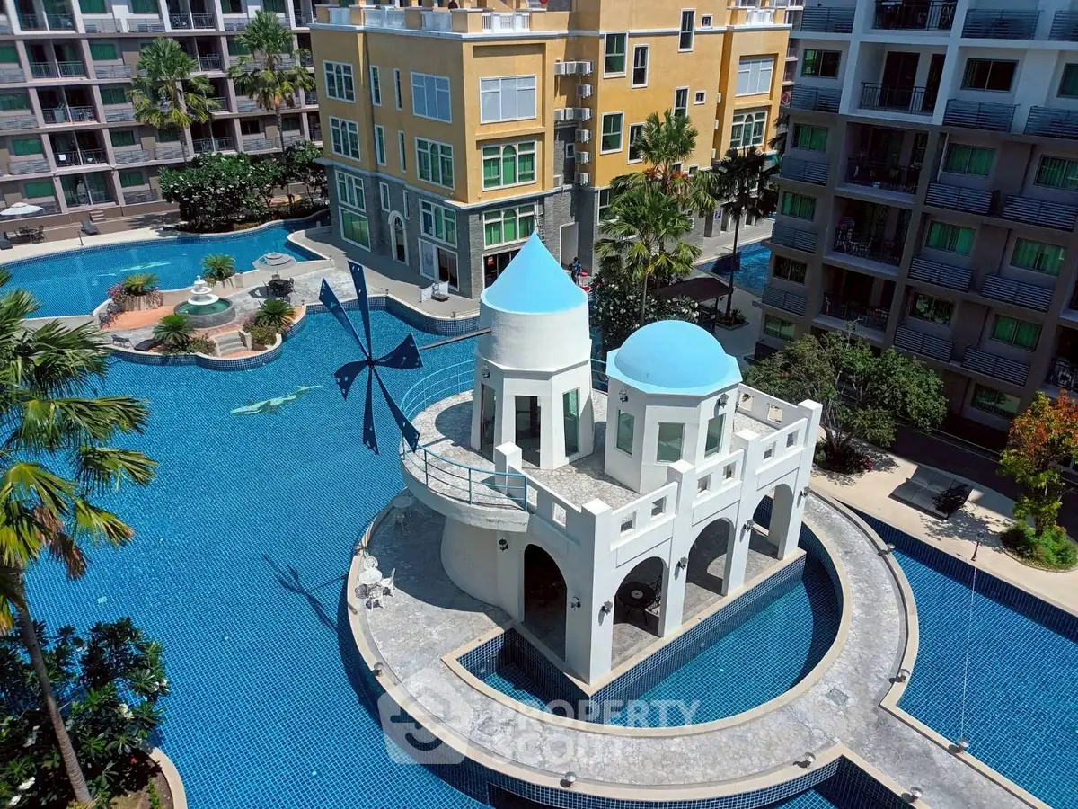 Luxurious apartment complex with stunning pool and unique architectural design.