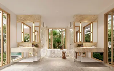 Luxurious marble bathroom with dual sinks and a central bathtub overlooking lush greenery.