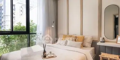 Cozy bedroom with large window and stylish decor in modern apartment