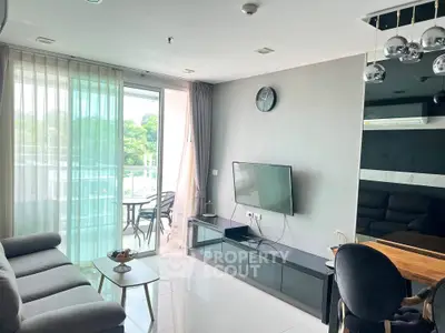 Modern living room with sleek furniture and balcony view