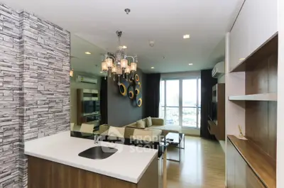Modern open-layout living room with stylish decor and city view from large windows.