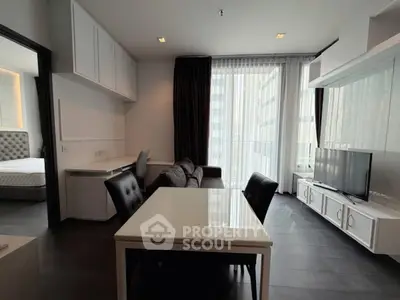 Modern living room with sleek furniture and large windows in a stylish apartment