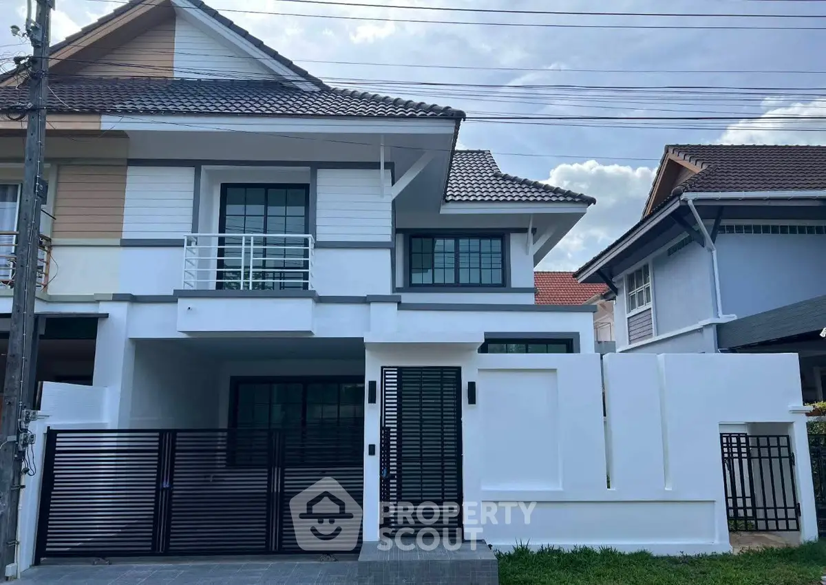 Modern two-story house with sleek design and gated entrance