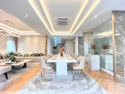 Luxurious open-plan living and dining area with elegant decor and modern lighting