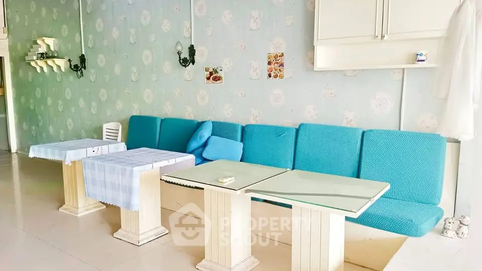 Charming living room with blue sofa and elegant decor, perfect for relaxation and entertaining guests.