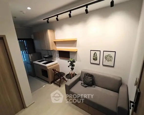 Modern compact living room with integrated kitchen and stylish decor.