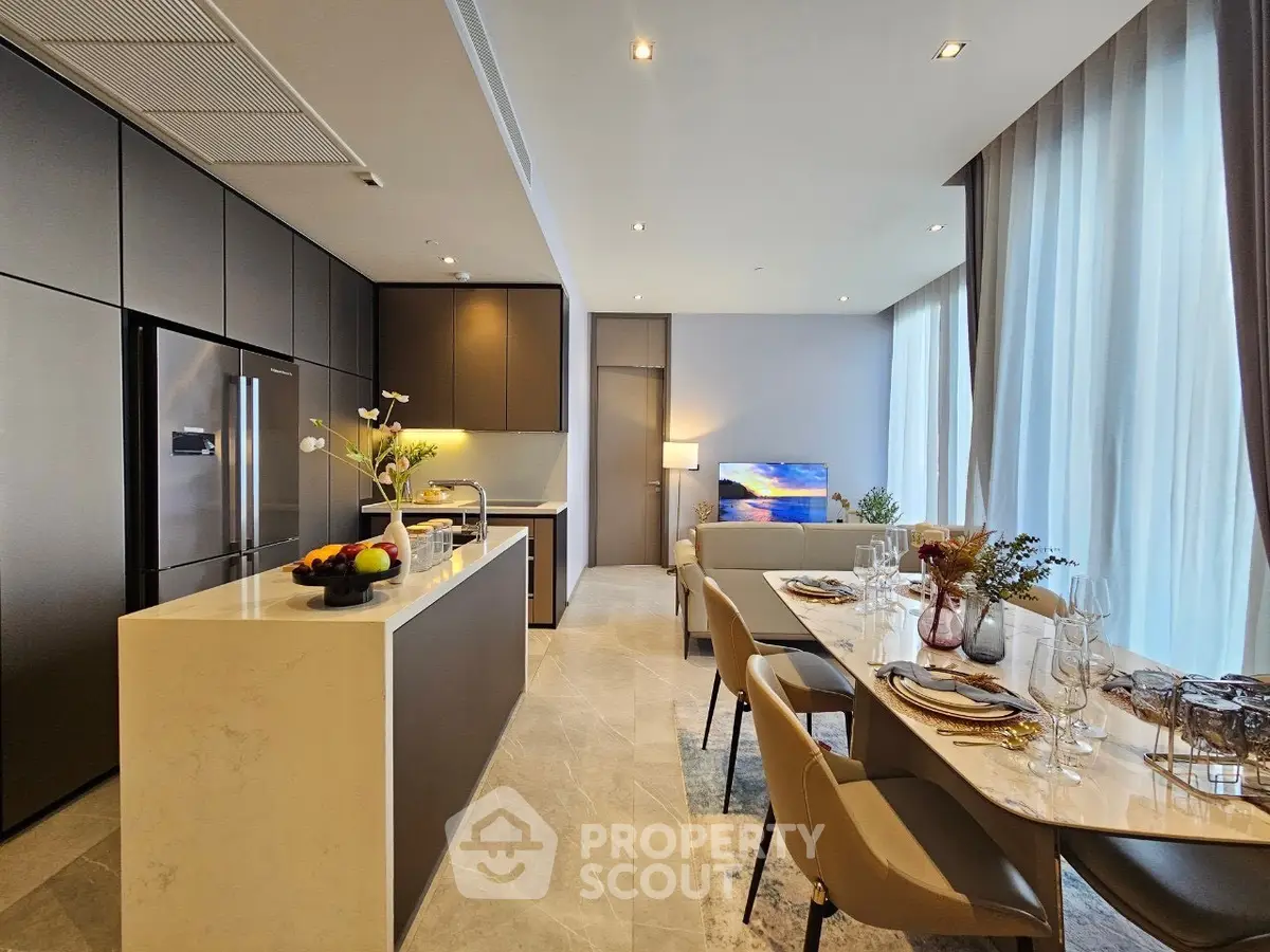 Luxurious open-plan kitchen and living area with elegant dining setup and modern appliances.