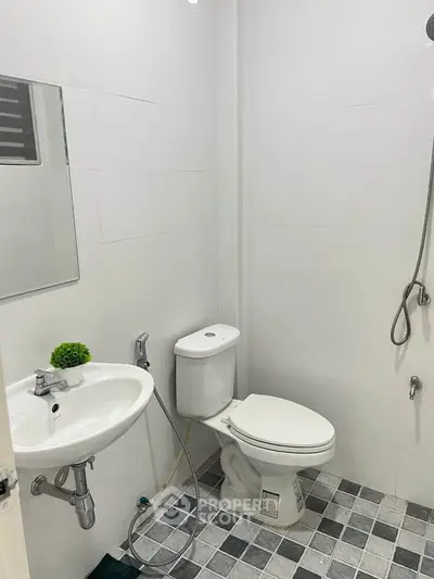Modern minimalist bathroom with white tiles and sleek fixtures