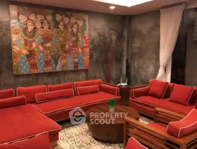 Luxurious living room with vibrant red sofas and artistic wall decor
