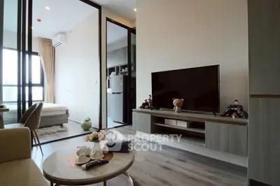 Modern living room with open layout, stylish furniture, and large windows for natural light.