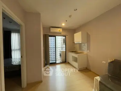 Modern apartment with compact kitchen and balcony view