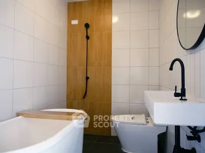 Modern bathroom with sleek fixtures and stylish wooden shower panel