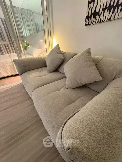 Cozy living room with plush beige sofa and modern decor