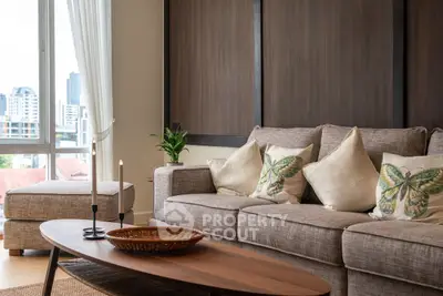 Elegant living room with cozy sofa and city view, perfect for relaxation.