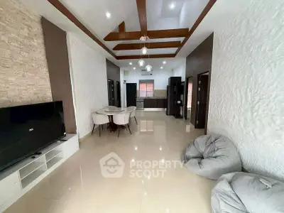 Spacious modern living room with elegant ceiling design and cozy seating area.