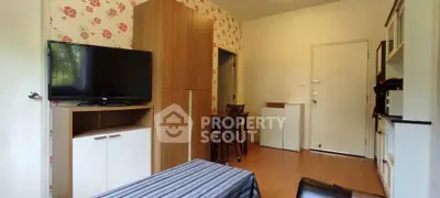 Cozy living room with modern furniture and floral wallpaper, perfect for relaxation.